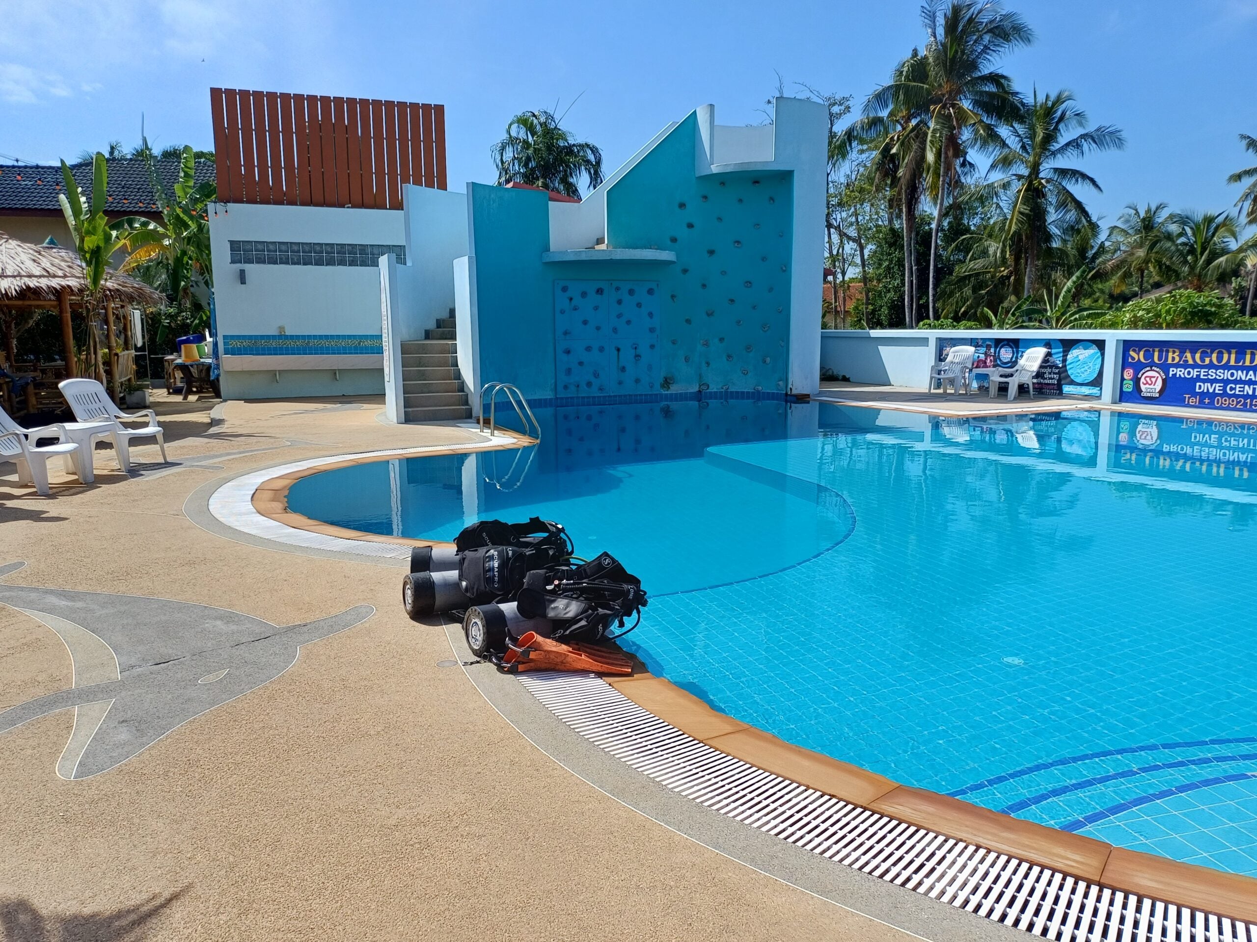 Thailand Divers scuba training pool with dive equipment prepared beside the water