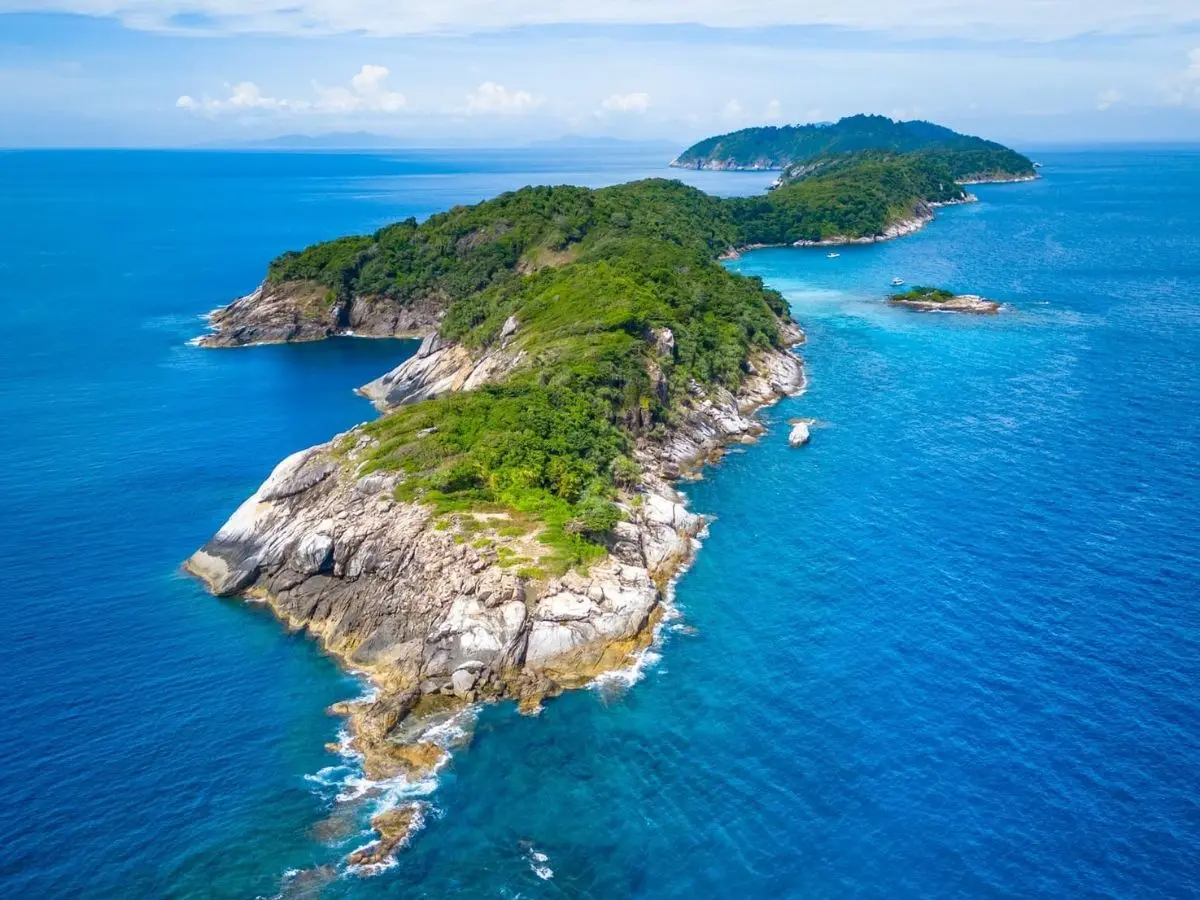 Green Racha island coastline surrounded by the blue Andaman Sea