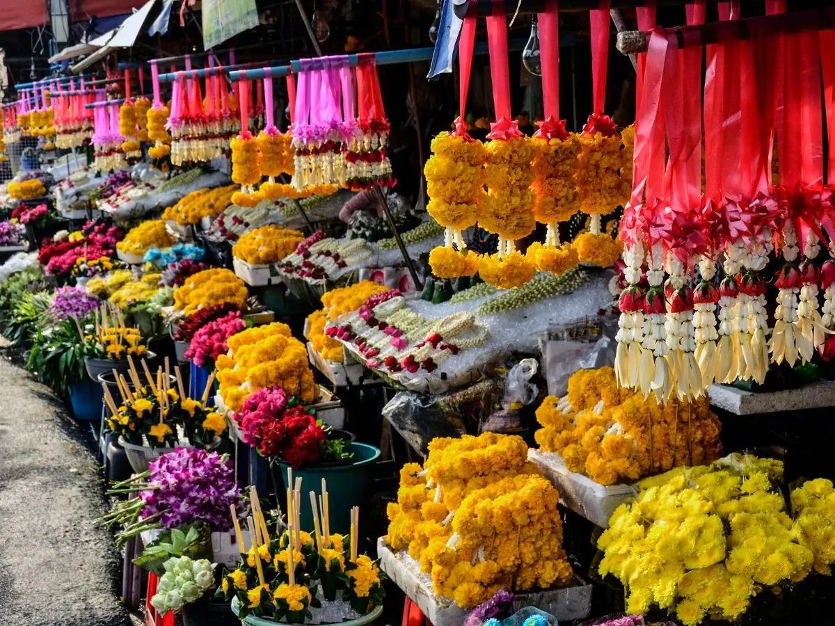 Colorful Thai flower garlands and bouquets on display at a local market