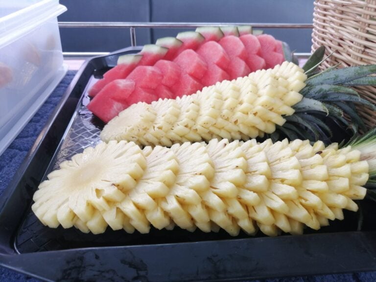 Fresh pineapple and watermelon prepared for guests aboard the private boat
